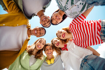 Happy group of young diverse friends enjoying a sunny day outdoors, bonding and capturing joyful...