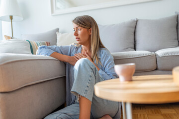 Worried Woman Sitting at Home Experiencing Anxiety and Emotional Distress