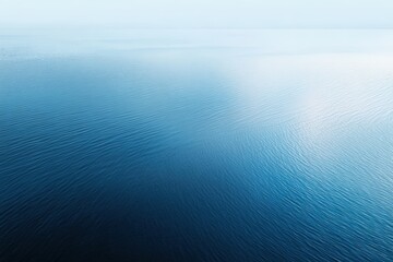 Tranquil blue water surface reflecting soft light, creating a serene atmosphere, ideal for relaxation and meditation themes in visual storytelling