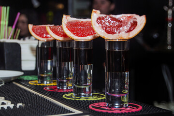 Delicious grapefruit shots on the bar counter	
