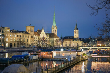 Evening view of the city of Zurich in Switzerland Several buildings and the tops of two churches are visible.