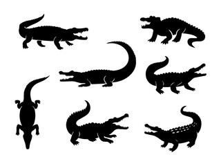 Collection of alligator silhouettes in various poses isolated on white background