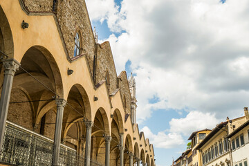 A multi-arched Gothic building in the city of Florence Italy the sky is blue and cloudy