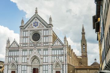 A large white church in Florence Italy Toscana with a blue cross on the front