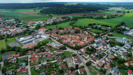 Aerial panoramic view around the old town of the city Lichtenau on a cloudy spring noon in Germany.
