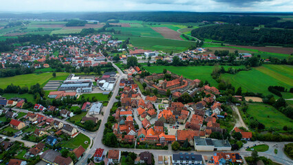 Aerial panoramic view around the old town of the city Lichtenau on a cloudy spring noon in Germany.