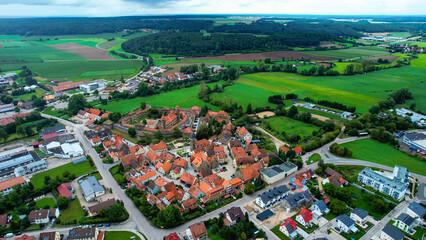 Aerial panoramic view around the old town of the city Lichtenau on a cloudy spring noon in Germany.