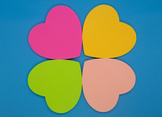 Colorful sticky notes in the shape of hearts on a blue background