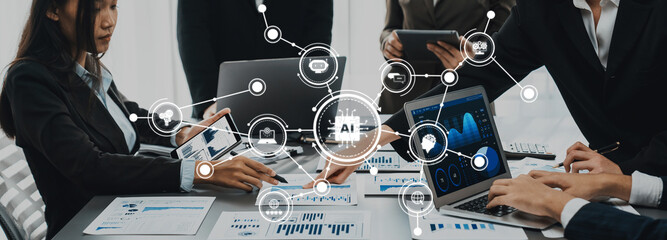 A dynamic business meeting featuring professionals engaged in discussion while utilizing advanced...