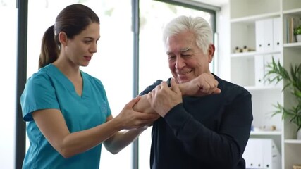 Therapist assisting patient with elbow movement: A compassionate therapist assists an elderly patient with elbow mobility in a professional clinical setting, emphasizing care.  - Powered by Adobe