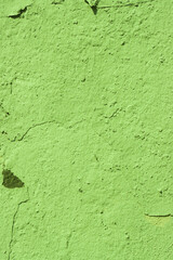 Vertical photo of a green concrete wall.