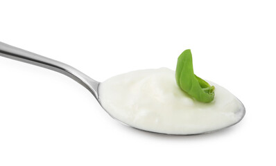Tasty yoghurt with basil in spoon isolated on white