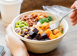 Colorful Vegan Salad Bowl with Quinoa, Roasted Veggies, beets and butternut squash, and edamame side view of Healthy Lunch