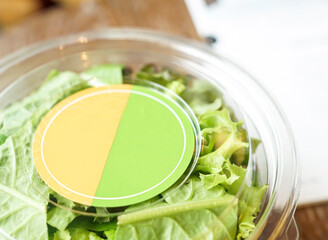 Fresh Green Salad in Clear Takeaway cup closeup view of healthy eating