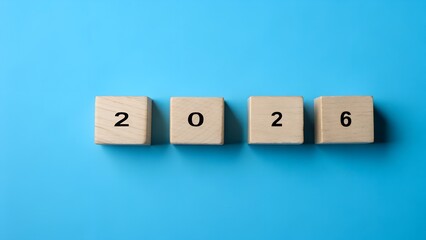 Wooden blocks display the year 2026 on a bright blue background