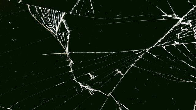 Slow-motion sequence of glass shattering against a black background for visual effects compositions. Crack Animation that looks like glass. footage of broken glass, crack screen glass.