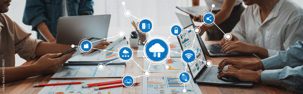 Poster a dynamic workspace showcasing collaboration around multiple laptops and devices. the image captures