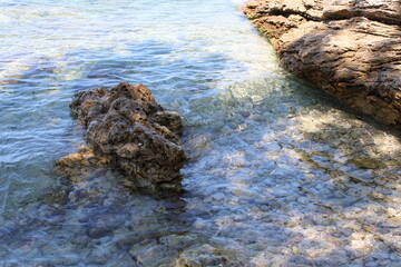 Rocky sea coast with clear turquoise ocean water, Murter, Croatia