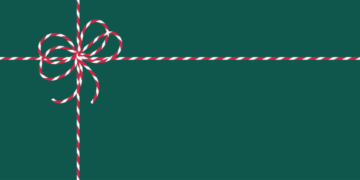 Christmas background with red white striped ribbon bow on dark green. Gift box backdrop. Perfect for holiday card, banner, packaging, gift wrap, invitation, seasonal web graphic, poster, digital ads