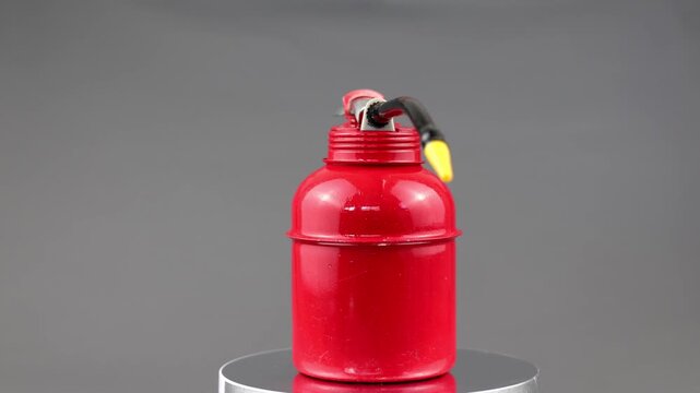 Oil can with red color isolated on grey background.
