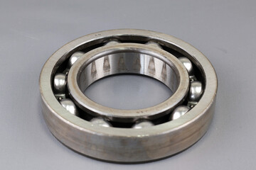 Ball bearing isolated on dark background. Automotive spare part company. Heavy industry engineering...