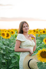 Smiling teenage girl in a field of sunflowers. Enjoying life.