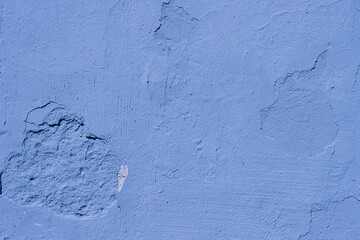damaged blue wall close up.