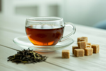 Aromatic hot tea with sugar cubes and loose leaf tea