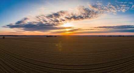 Stunning sunset over vast rural landscape with dramatic cloud formation