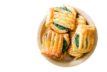 Top view, puff pastries stuffed with spinach, in cardboard plate