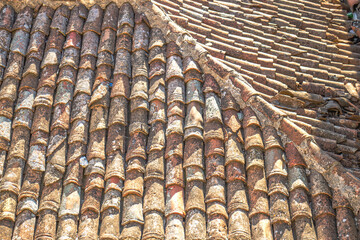 Roofing, waterproofing. Surface. Old worn tiles. Building material background. Red tiles that...