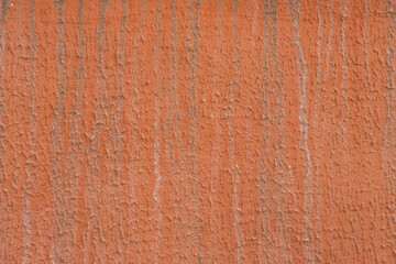 Old orange wall with stains and vertical stripes.