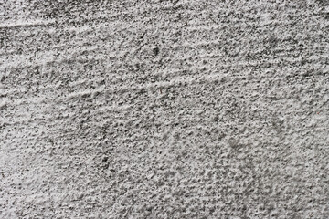 A rough, time-damaged concrete wall.