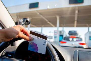 Cars passing through checkpoint to pay road toll at highway. 