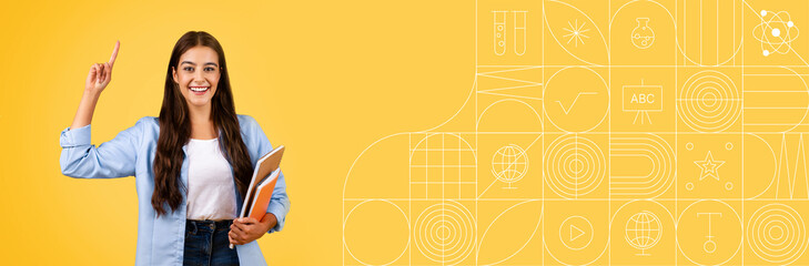 A motivated student happily studies with books in hand against a bright yellow background. This...