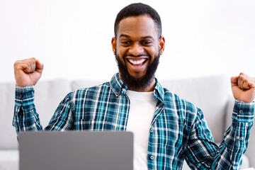Joyful African Businessman At Laptop Gesturing Yes Celebrating Business Success At Work Sitting In...