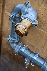 Piping and connection on a stone wall