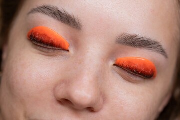 Caucasian woman undergoing eyelash lamination procedure. top view. 