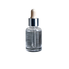 Clear glass dropper bottle with serum resting on stacked grey stones isolated on transparent background