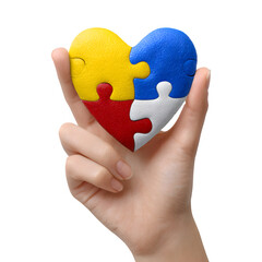 Hand holding a heart shaped puzzle symbolizing love and connection isolated on transparent background