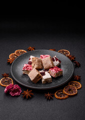 Nougat or white caramel with hazelnuts and pistachios and strawberry pieces. Nougat with nuts