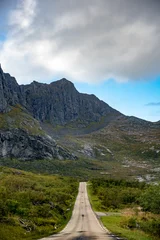 Papier peint photo  Remote Mountain Road: Unending Path Through Rugged Peaks & Vast Wilderness Under Dynamic Skies – For Adventure Travel  © Richard