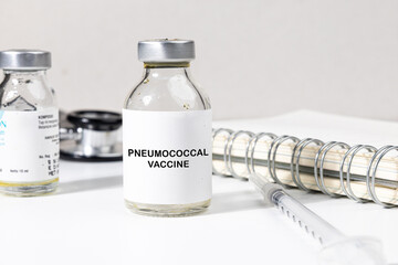 A Vaccine Bottle with "Pneumococcal Vaccine" Label Set on the Desk Accompanied by a Syringe and Stethoscope, Highlighting Protection Against Pneumonia and Related Infections
