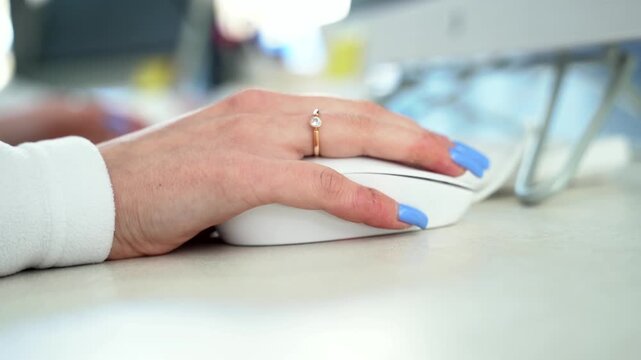 Close up of female administrator hand using mouse working on computer Technology and business concept.
