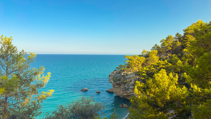A beautiful coastal view with turquoise waters and lush greenery invites exploration and...