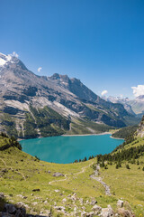 Obraz premium Lake Oeschinen in Switzerland, beautiful swiss mountain lake and world heritage. Panorama view of the lake.