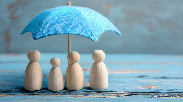 Family protecting with insurance, small wooden figures under umbrella