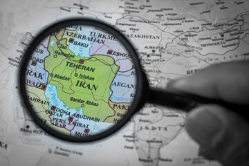 Iran on the world map, viewed through a magnifying glass, highlighting its location and...