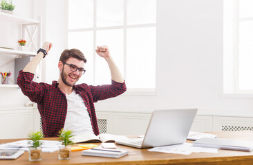 Winner businessman happy, successful, in white modern office, sitting at workplace. Man in eye...