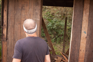 man building his own shack
